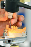 Dental technician measuring dentures