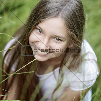 portrait of beautiful teen girl on the grass