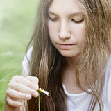 teenage girl wonders on flower