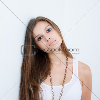 young female leaning against the wall