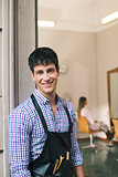 portrait of man working as hairdresser and smiling
