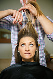 nervous woman in hairdresser shop cutting long hair
