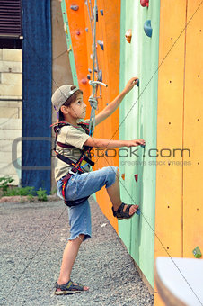 child climbing up the wall