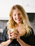 Beautiful blond holding a large coffee