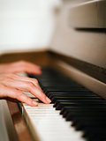 Female hands and piano keyboard