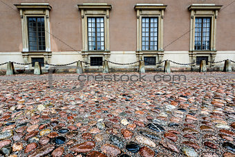 Wet Cobblestone and King Palace Facade in Gamla Stan (Old Town) 