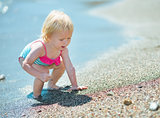 Baby playing on beach