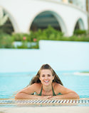 Portrait of happy young woman in pool