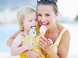 Happy mother and baby eating ice cream