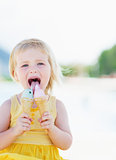 Happy baby eating two ice cream horns