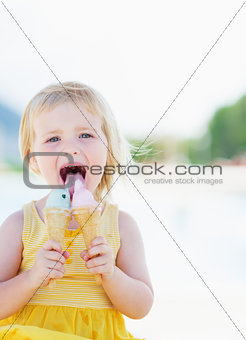 Happy baby eating two ice cream horns