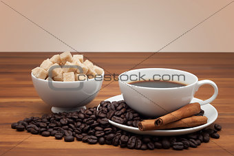 Coffee cup and cube sugar on a wooden table