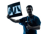 doctor surgeon radiologist examining lung torso  x-ray image thu