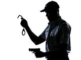 Policeman holding handcuffs and handgun