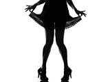stylish silhouette woman legs pulling her summer dress