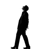 silhouette  man walking musing looking up