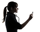 woman doctor holding stethoscope silhouette