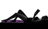  woman lying reading book in bed silhouette