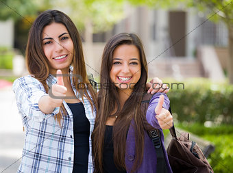Mixed Race Female Students on School Campus With Thumbs Up 