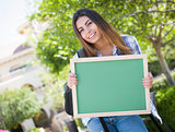 Excited Mixed Race Female Student Holding Blank Chalkboard