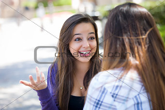 Expressive Young Mixed Race Female Sitting and Talking with Girl