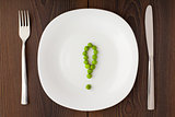 Exclamation mark made of peas on a plate