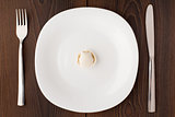 One ravioli on white plate