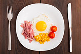 Fried egg with ham and vegetables