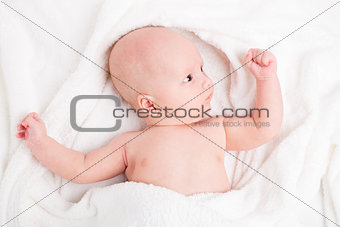 Cute baby wrapped into towels