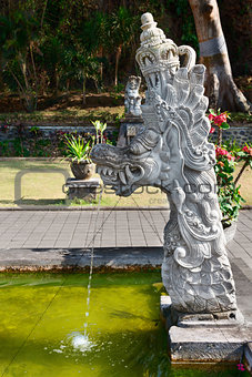Fountain with traditional Balinese stone dragon statue