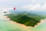 Aerial view of the tropical shore under airplane
