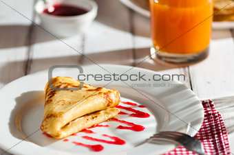 folded pancake on white plate