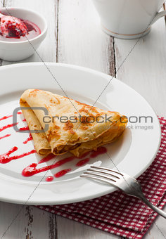 folded pancake on white plate