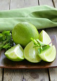 Fresh limes with green mint - chopped and whole