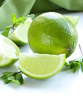 Fresh limes with green mint - chopped and whole