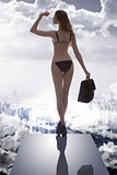 girl with bikini and business bag in drammatic light