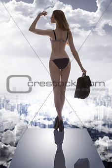 girl with bikini and business bag in drammatic light
