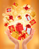 Holiday background with hands holding gift boxes. Concept of giv
