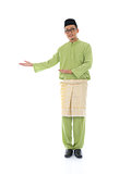 Traditonal Malay man with welcome gesture during ramadan isolate