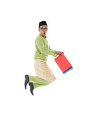  indonesian male shopping and jumping in joy during hari raya ra