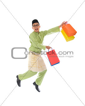  indonesian male shopping and jumping in joy during hari raya ra