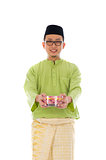 Traditional Malay male with biscuit during hari raya