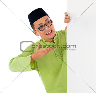 malay male with blank card during hari raya Eid al-Fitr celebrat