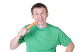 Young man eating an organic carrot