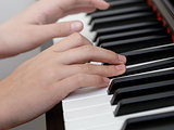 close up photo of girls hands playing on piano