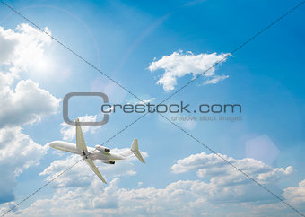 an airplane flying above blue clouds