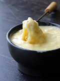 cheese fondue - a piece of bread (croutons) in a liquid cheese