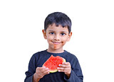 3 year south Asian boy enjoying eating watermelon