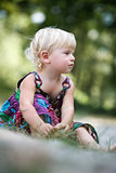 little girl sitting on the ground