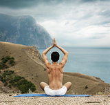 Man Doing Yoga at the Sea and Mountains